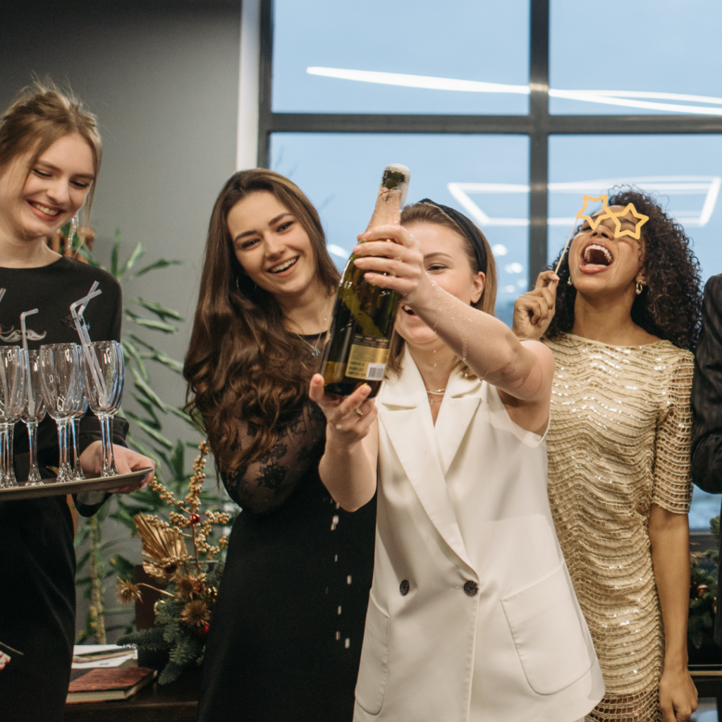 Vier Frauen stossen lachend mit Sekt an, Stimmungsbild im Beautylounge Blog.
