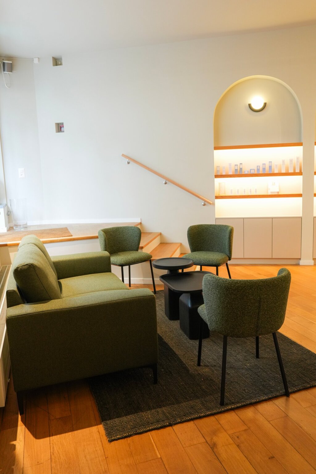 Wartebereich mit gr&uuml;nem Sofa und Regal in der Beautylounge Basel 1 an der B&auml;umleingasse.