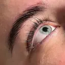Nahaufnahme eines Auges mit gepflegten Wimpern und Augenbrauen in der Beautylounge.